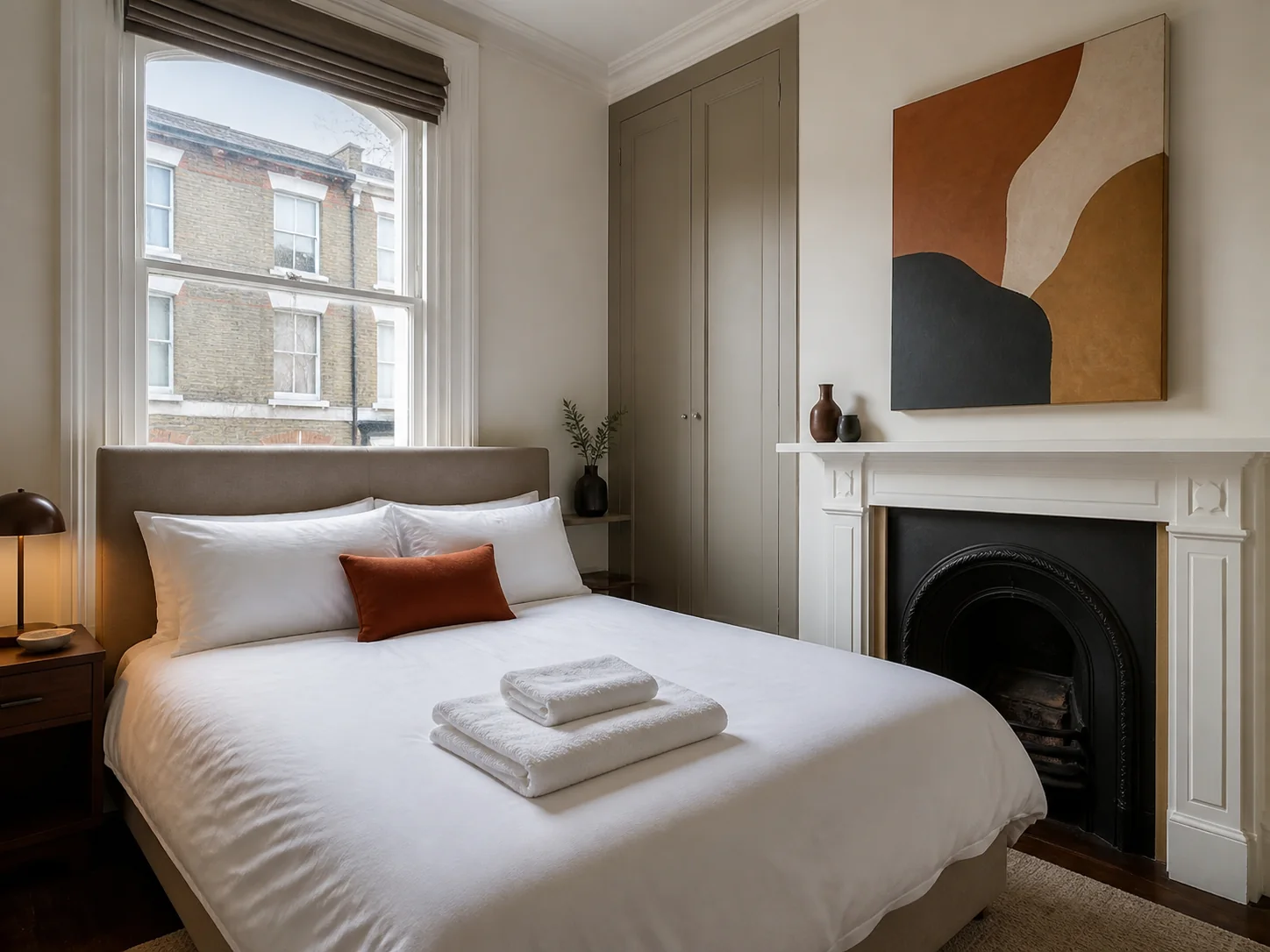 Freshly prepared Airbnb bedroom with white linen and towels in Lambeth